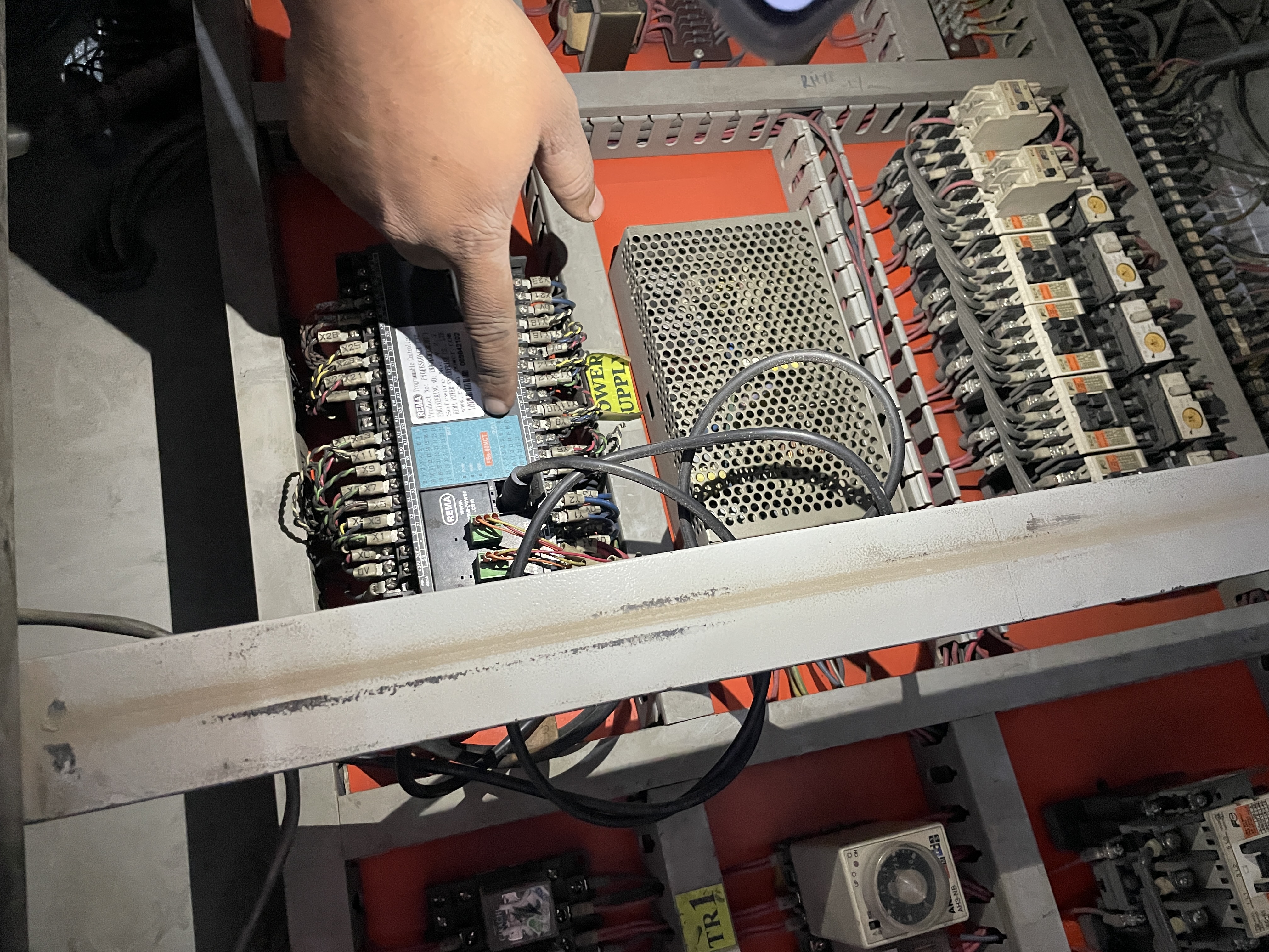 Inside an active control panel — Fuji SC-0 contactor bank, terminal blocks, and 24 V control wiring. Hand-tracing a control loop during fault diagnosis.