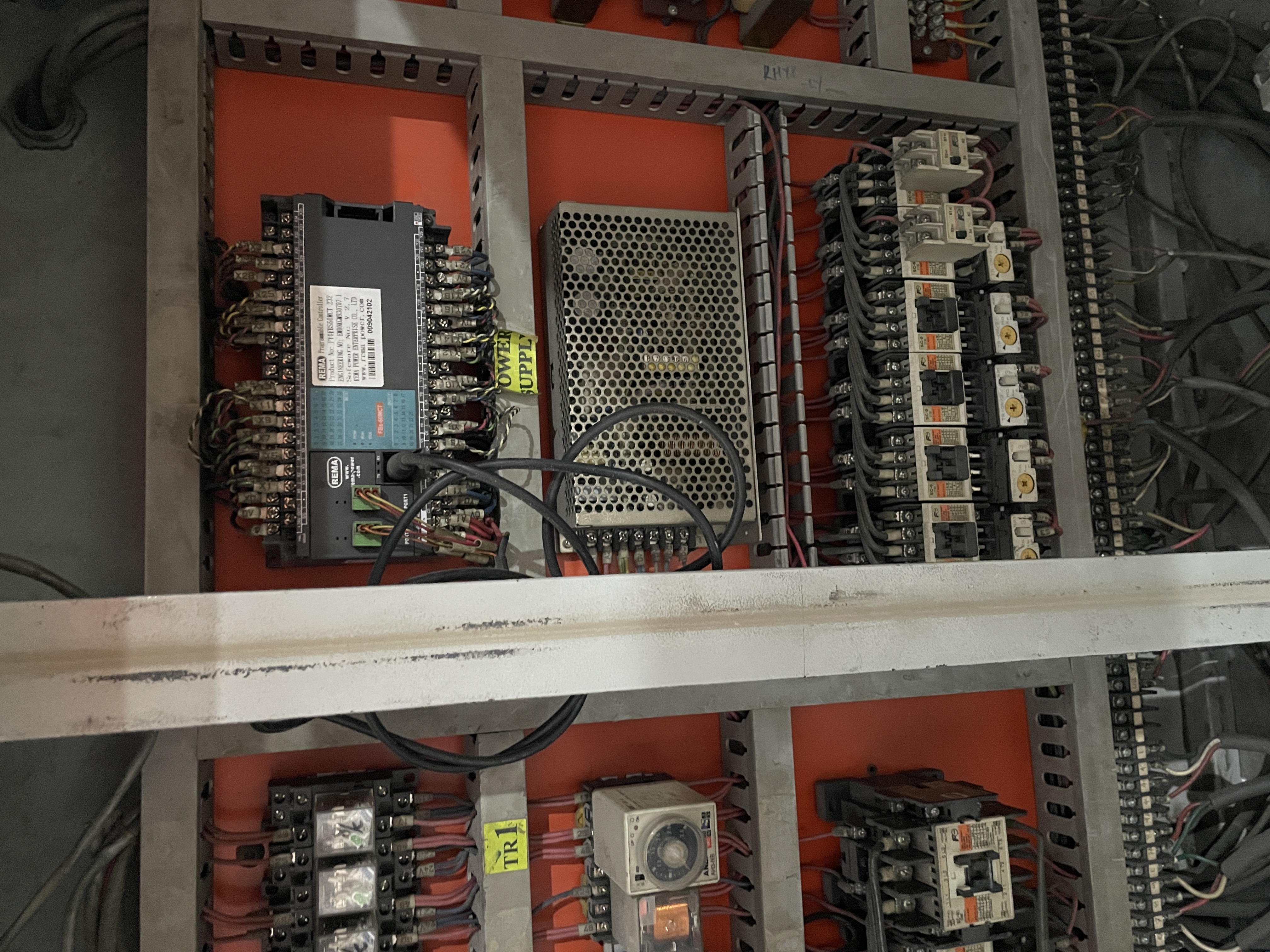 Working live inside the cabinet — control circuit verification before re-energizing.